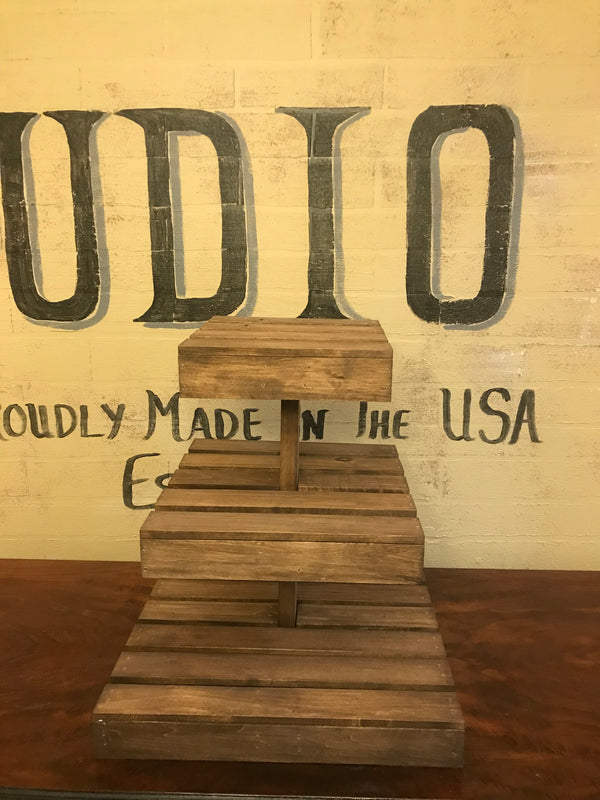 Rustic medium cupcake stand made of dark stained wood, empty three-tier design.