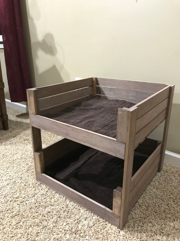 Two-tier wooden pet bed with cozy bedding in medium brown