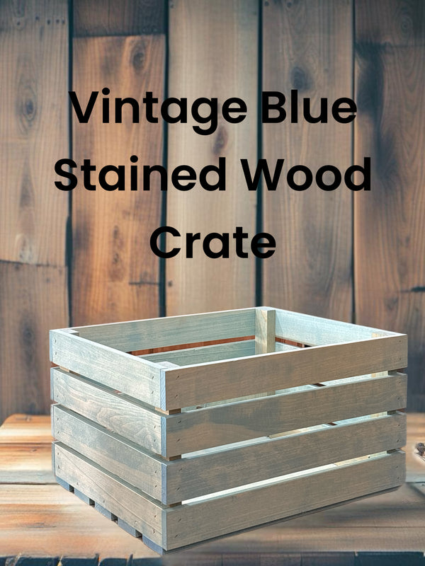 Vintage blue stained wood crate with farmhouse background and bold text label.