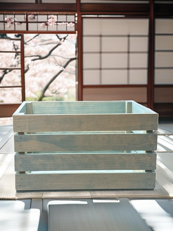Vintage blue stained wood crate styled in Japanese room with cherry blossoms.