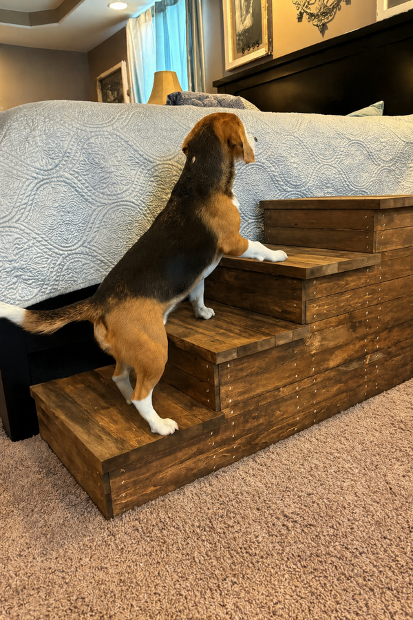 4 step wooden pet stairs in Early American stain beside a bed in a bedroom