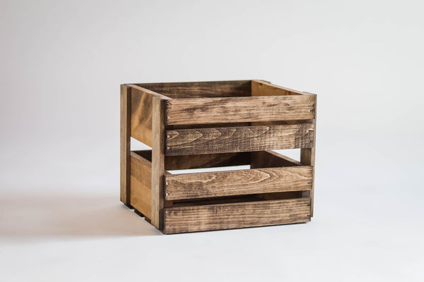 Side view of rustic wooden 78 RPM record storage crate on white background