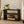 Small wooden bookshelf in Dark Walnut stain beside a desk with books and decor in a home office