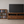 Early American wooden DVD storage rack filled with movies in a bedroom or media room