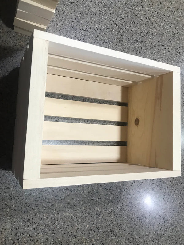 Empty wooden crate designed to hold natural wooden toy blocks