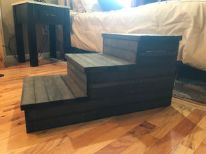 Handmade wooden 3-step pet stairs in dark walnut finish beside a cozy bedroom bed.