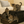 Three kittens playing on a rustic wooden 2-step stool in dark walnut finish near a bed.