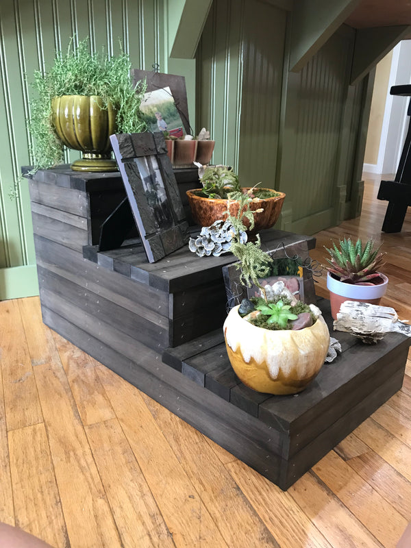 Handmade rustic 3-step wooden stairs used as a display stand for decor and plants.