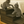 Two kittens playing on rustic dark walnut 3-step wooden pet stairs beside a bed.