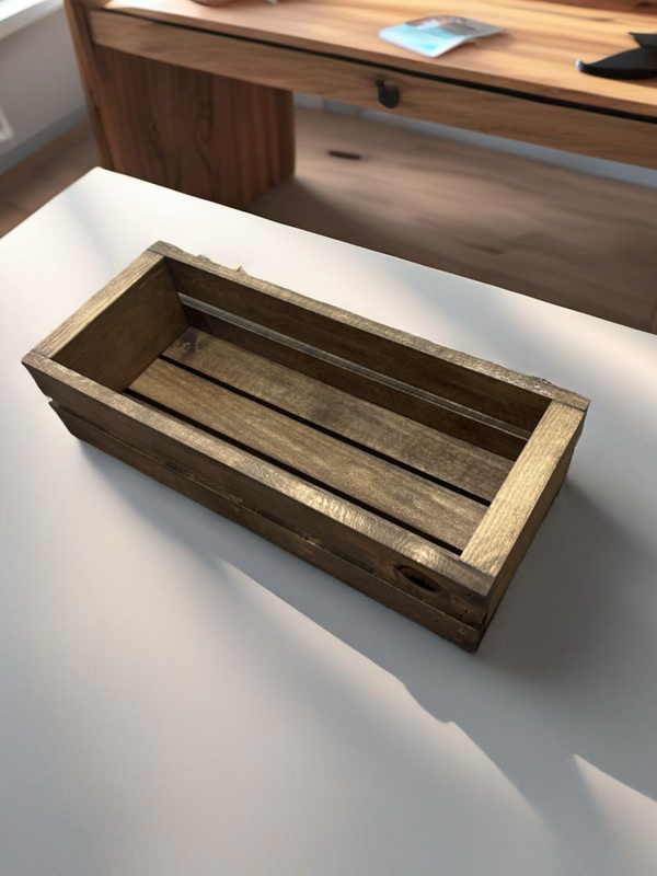 Small wooden cassette tape holder on a modern office desk.