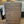 Bottom view of wooden under-bed storage drawer showing rolling casters