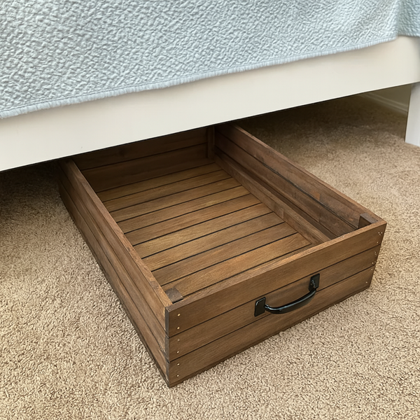 Rustic wooden under-bed storage drawer shown under white bed frame
