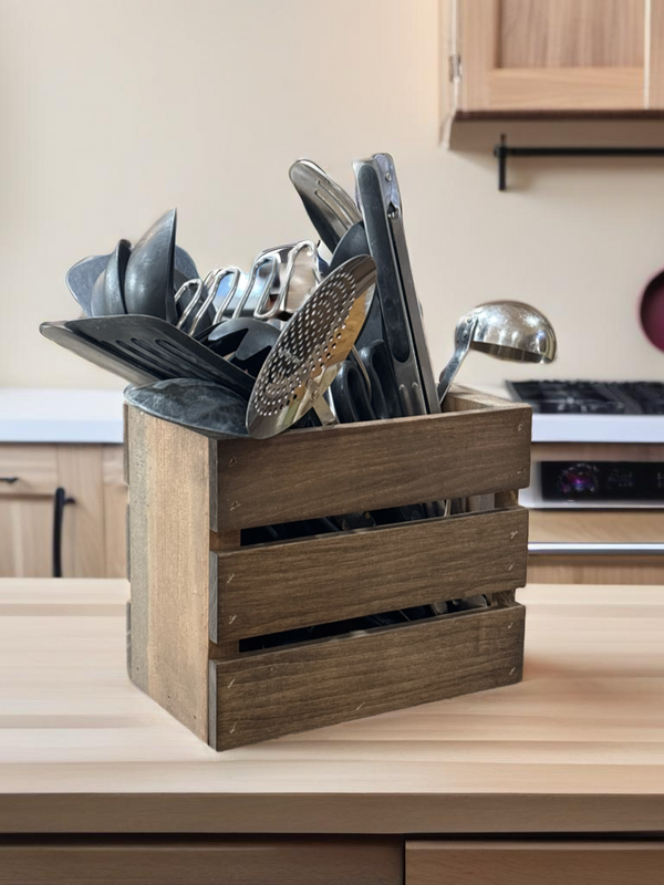 Rustic utensil holder wooden crate full of utensils on countertop