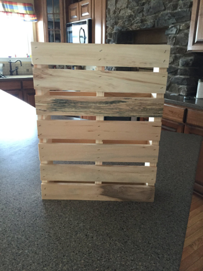 Wooden pallet shown standing upright on a counter