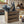 Rustic wooden utensil holder crate filled with cooking utensils on counter