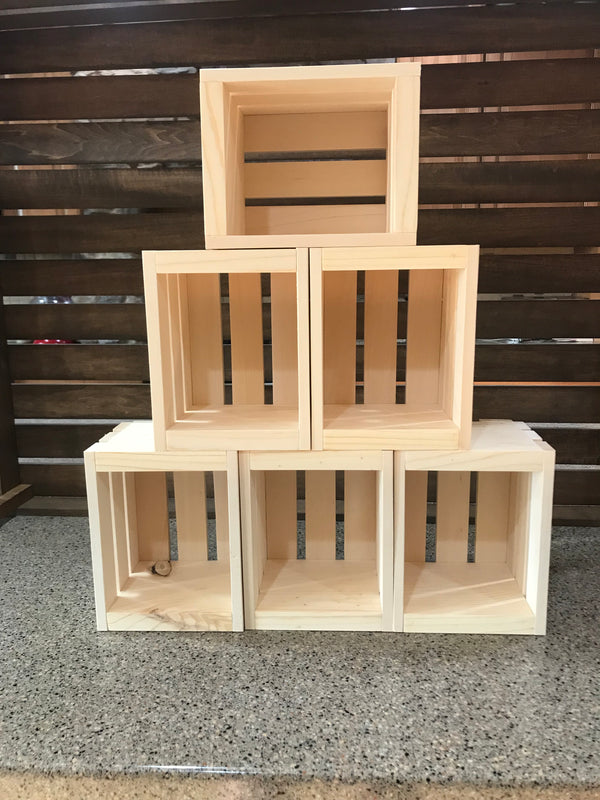 Six natural wood crates stacked in a pyramid formation for versatile farmhouse storage.