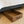 Wooden under-bed storage drawer under modern bed with white quilt