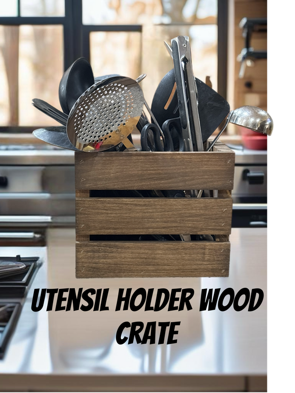 Rustic wooden utensil holder crate filled with cooking utensils on counter