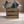 Close-up of rustic wooden utensil holder crate with utensils
