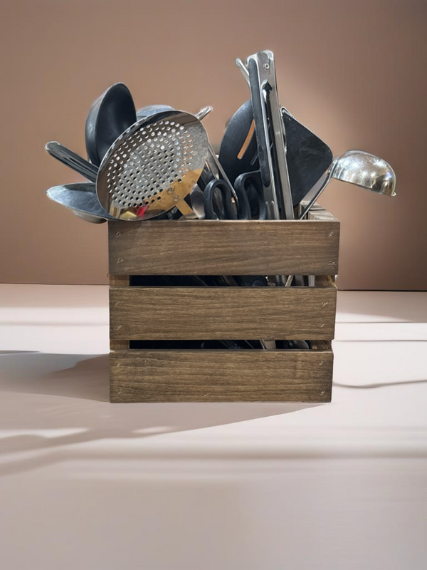 Close-up of rustic wooden utensil holder crate with utensils