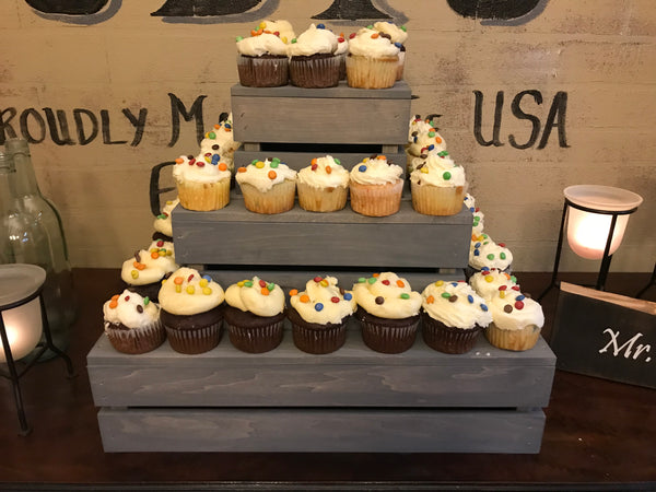 Close-up detail of cupcakes displayed on an antique gray 3-tier wooden cupcake stand.