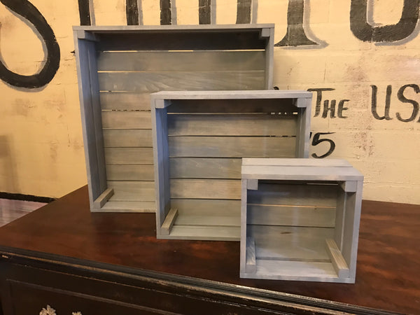 Empty antique gray 3-tier wooden cupcake stand showing stacked crate construction.