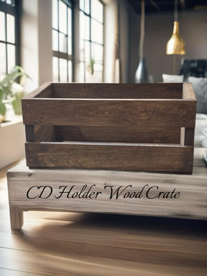 Wooden CD holder crate labeled “CD Holder Wood Crate” sitting on rustic coffee table.