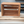 Empty cherry stained wooden record holder crate for 45 RPM vinyls