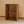 Side view of cherry stained 2-tier wooden turntable stand for records and storage.
