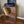 Rustic cherry stained 2-tier wooden turntable stand with vinyl records and record player.