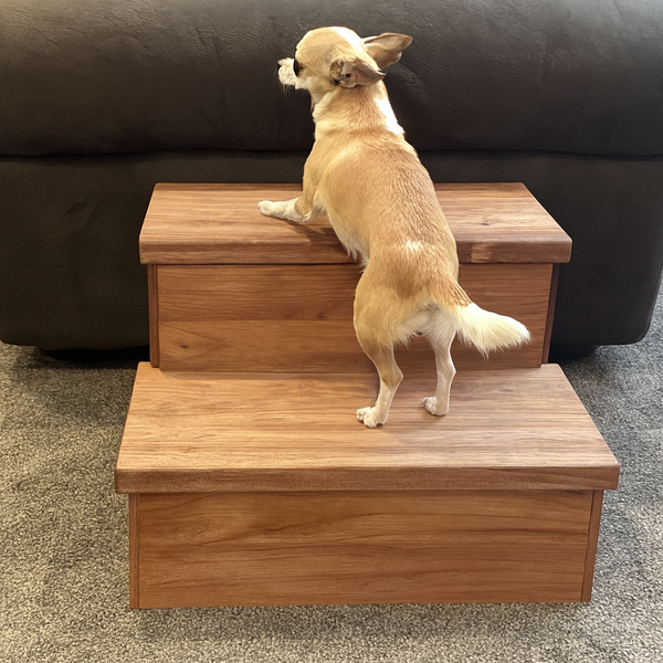 Small dog using cherry stained two-step wooden pet stairs