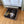 Crate-style small dog bed in medium brown finish with dog inside