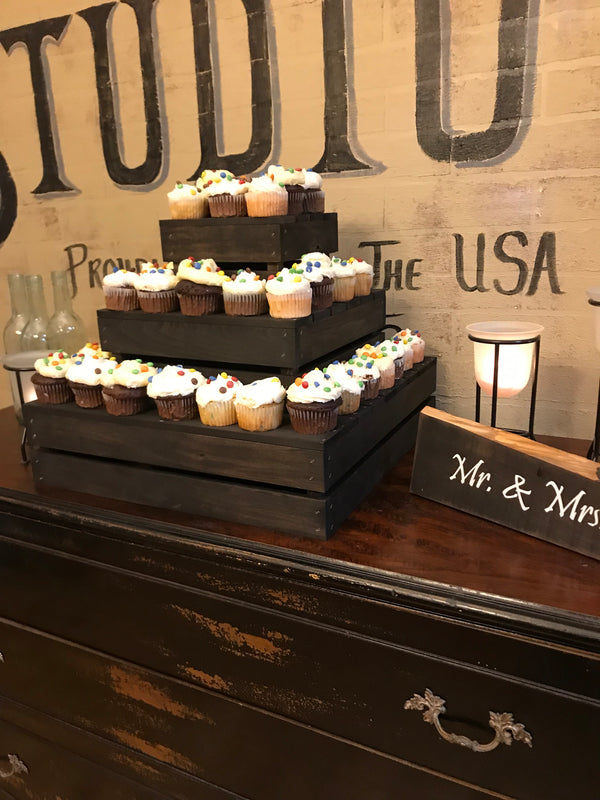 Dark rustic 3-tier wooden cupcake stand styled for a party event with cupcakes