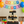 Handmade rustic dark cupcake stand showcased at a birthday party with colorful balloons and cupcakes.