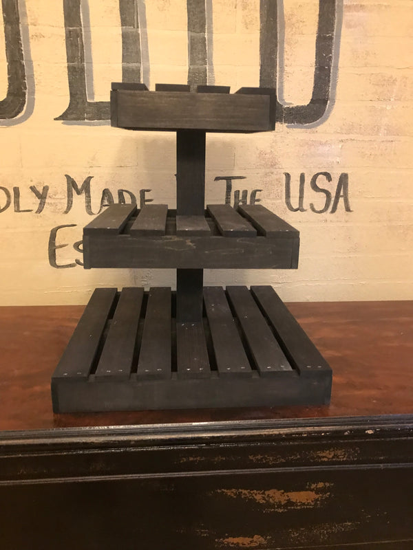 Empty three-tier rustic dark cupcake stand made from wood, perfect for weddings and events.