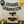 Rustic dark wooden cupcake stand filled with cupcakes at a retirement party with balloons and banner.