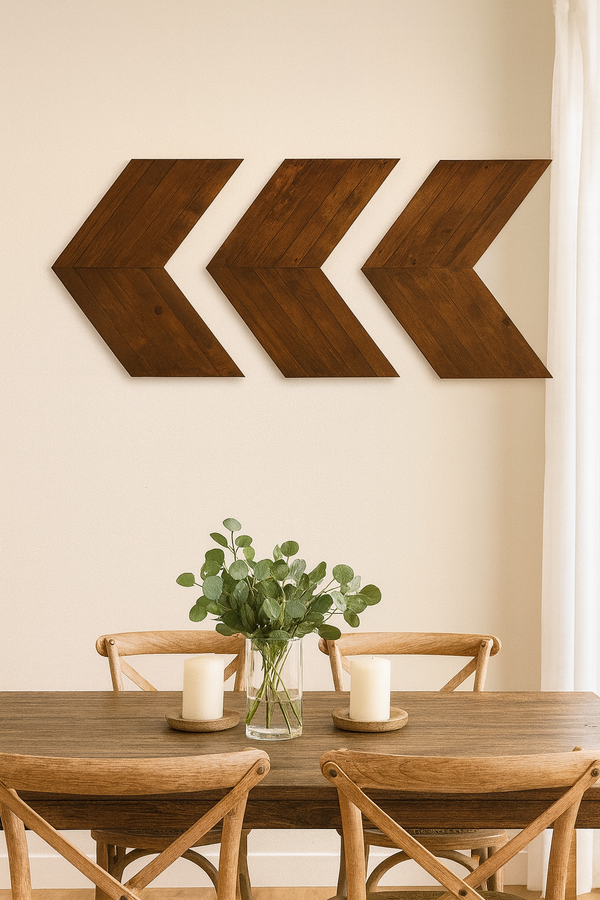 Dark walnut wooden chevron arrows hanging above dining room table, rustic wall art