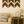 Set of rustic dark walnut chevron arrows displayed in living room above couch