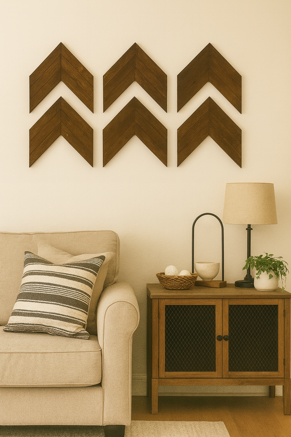 Set of rustic dark walnut chevron arrows displayed in living room above couch