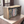Rustic wooden DVD holder crate on table, filled with movies.