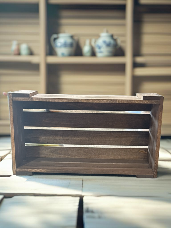 Empty rustic DVD holder wooden crate, angled front view.