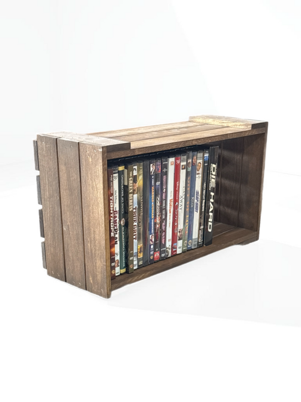 Rustic wooden DVD holder filled with movies, white background.