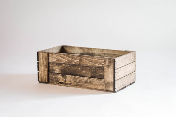 Empty rustic wood DVD storage crate, studio white background.