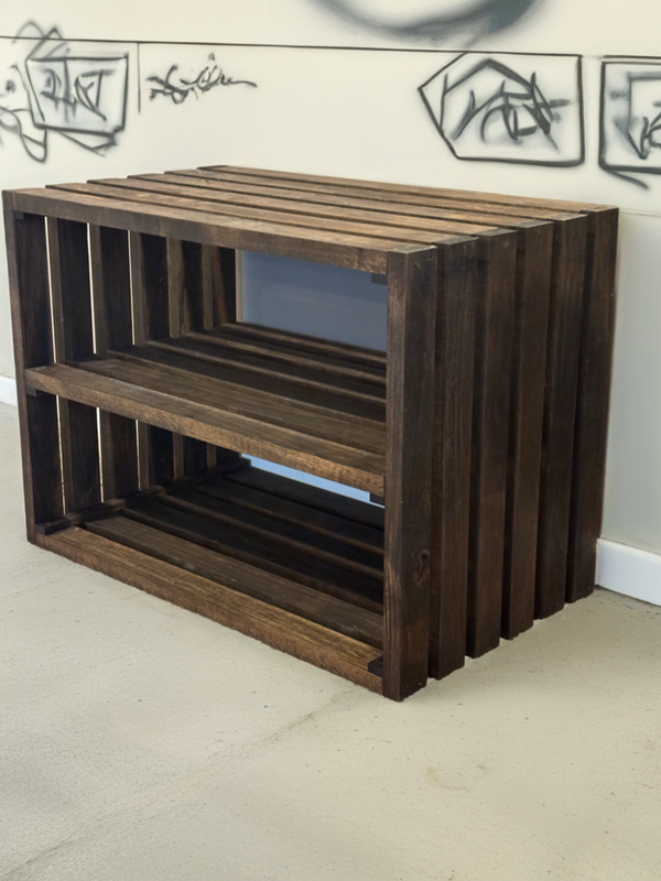 Rustic entryway shoe rack in dark walnut finish against wall with graffiti