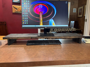 40-inch rustic wooden monitor stand on desk with keyboard stored underneath