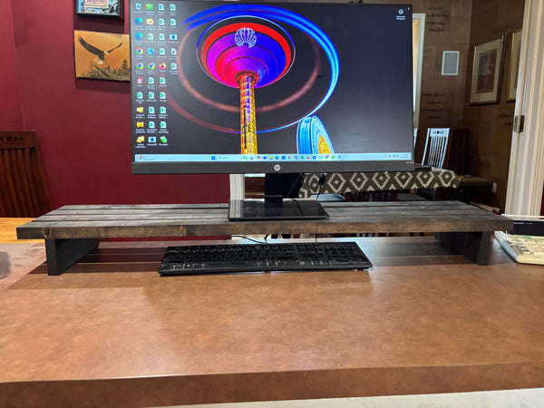 40-inch rustic wooden monitor stand on desk with keyboard stored underneath