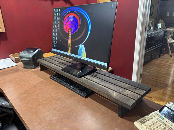 Extra-wide 40-inch wooden monitor stand with computer monitor and desk accessories