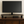 40-inch rustic wooden monitor stand holding flat screen on desk