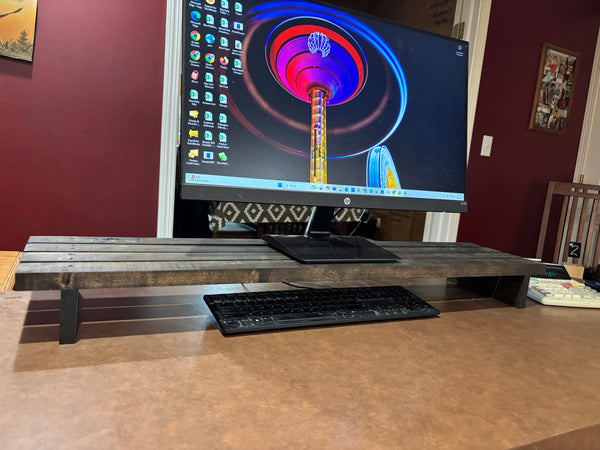Front view of rustic 40-inch wooden monitor riser with slatted surface