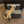 Small dog using rustic gray 2-step wooden stairs to climb onto a couch, perfect for pets.